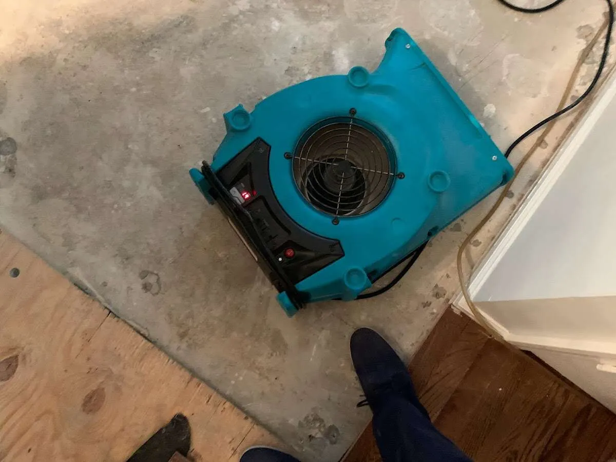 Air mover drying subfloor during Commercial Water Damage Restoration in National City